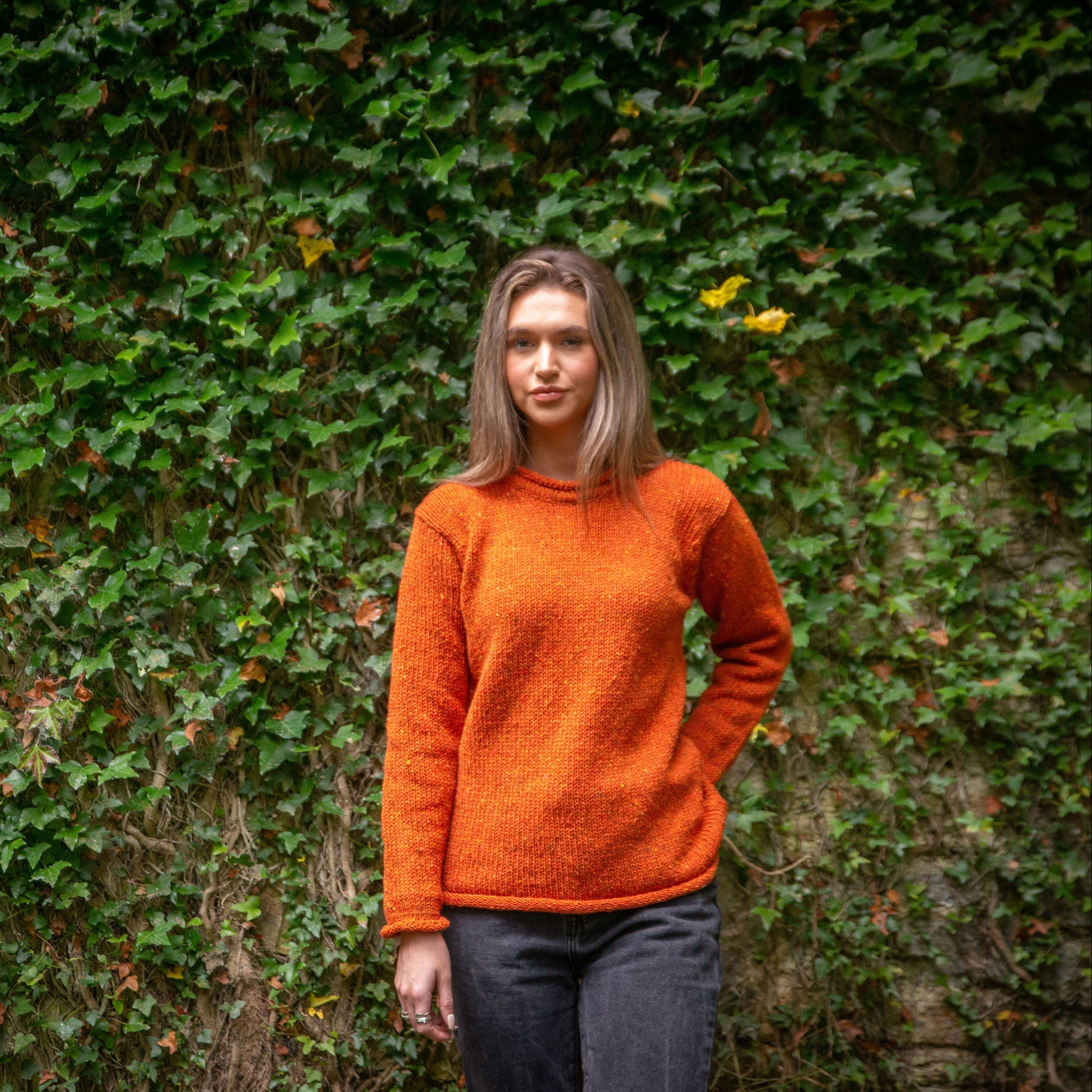 copper orange ladies jumper in the outdoors
