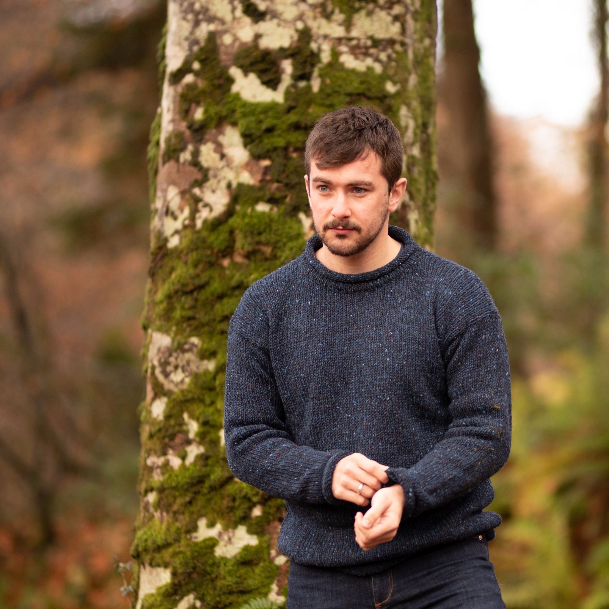 Man wearing a midnight blue roll neck wool sweater made in Ireland