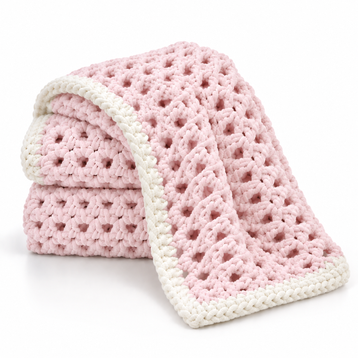A pink and white crocheted baby blanket with a textured openwork pattern and a solid white border, folded neatly on a white background.